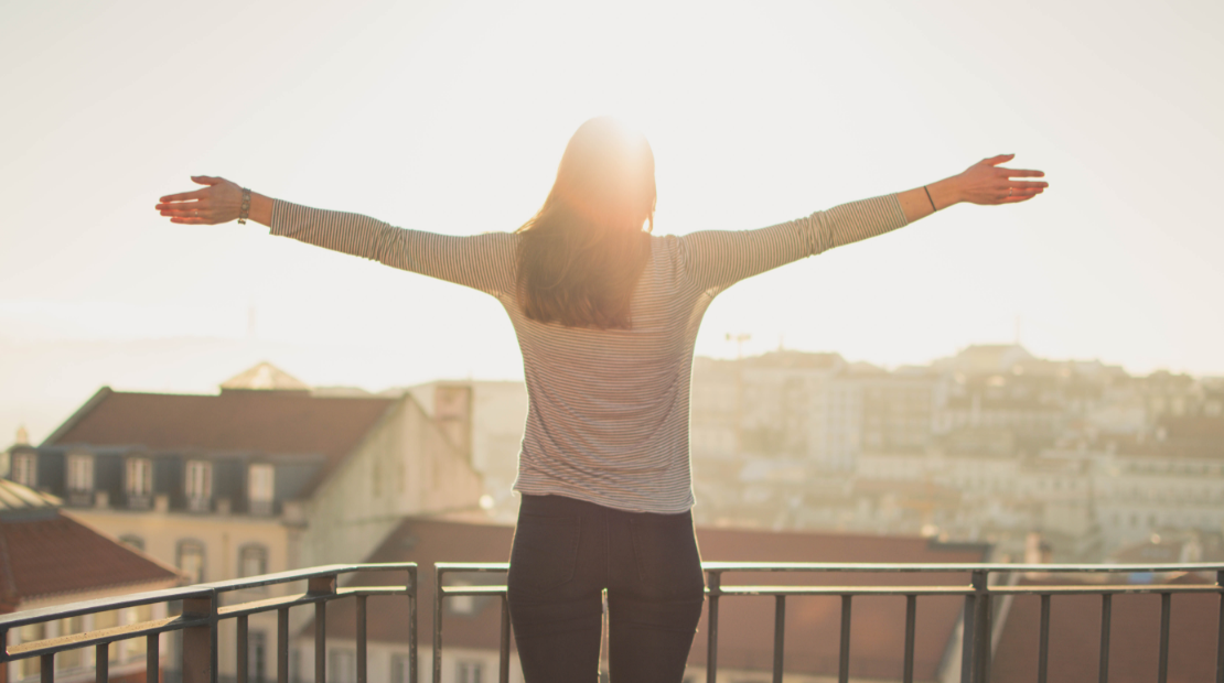 woman on sweater facing the sun